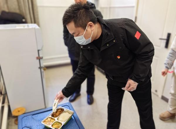 3鄭州市第七初級中學(xué)東校區(qū)黨支部書記楚東升，用專用測溫計進(jìn)行餐溫測量